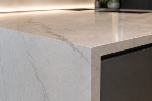 Vein-matched stone benchtop continuing onto a waterfall edge in a modern kitchen